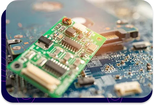 Nahaufnahme einer grünen Leiterplatte (PCB) mit elektronischen Bauteilen, die auf einem größeren blauen integrierten Schaltkreis liegt.